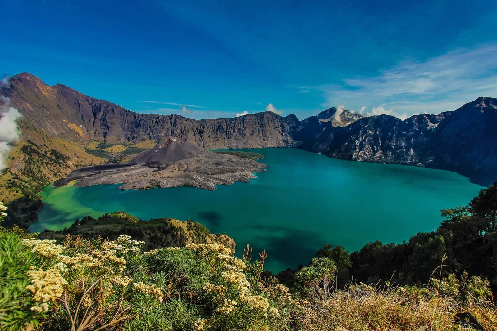 Le lac de cratère Segara Anak sous un ciel bleu, dans la caldeira du Rinjani à Lombok